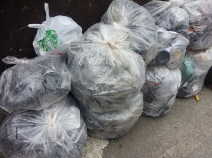 Waste behind a local cafe, these bags are filled mostly with plastic cups/lids/straws.